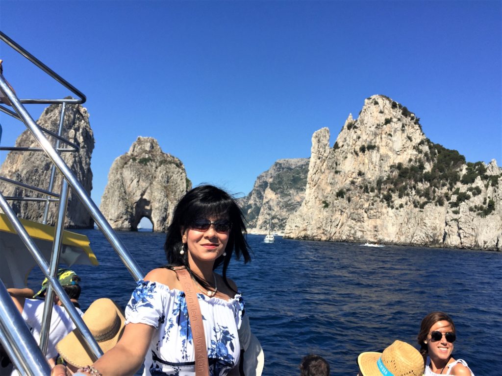 A brief stop during the boat tour near the iconic Faraglioni Rocks of Capri