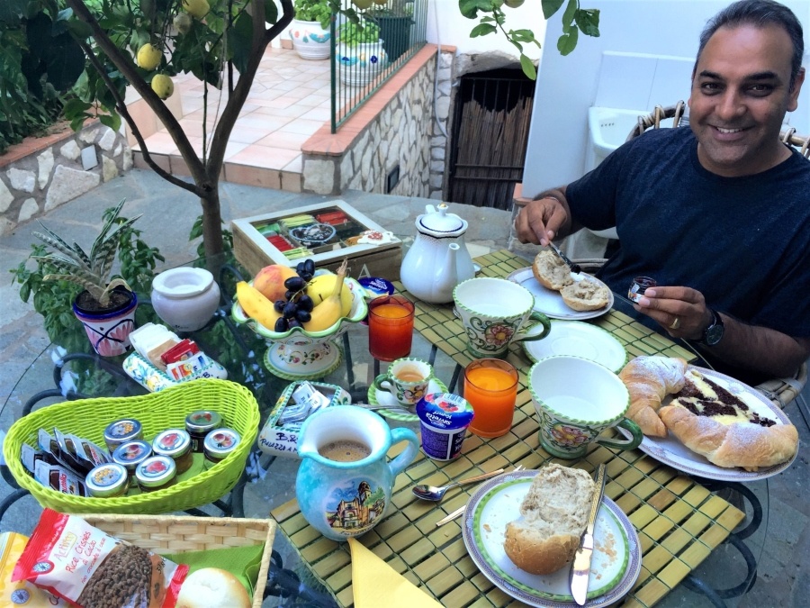 Visiting Capri, Italy – breakfast under lemon trees at a charming B&B with fresh pastries, fruit, and Italian coffee.