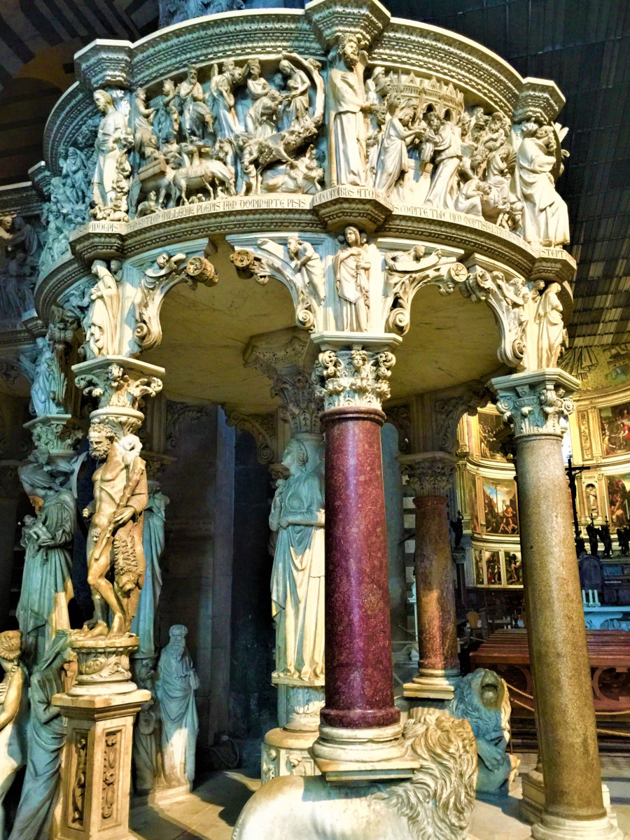 Close-up of Giovanni Pisano’s marble pulpit inside Pisa Cathedral showing biblical reliefs and sculpted figures supported by ornate columns