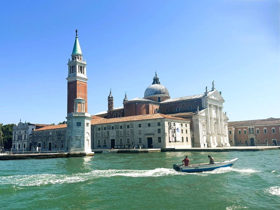 View of San Giorgio Maggiore across the Venetian Lagoon with a small boat passing by, en route from Venice to Murano