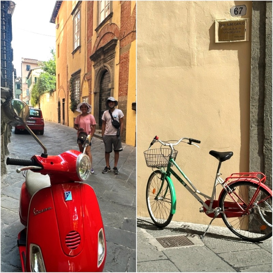 A red Vespa scooter and green bicycle parked along the narrow streets of Lucca, Italy — a glimpse of everyday Tuscan life and color.