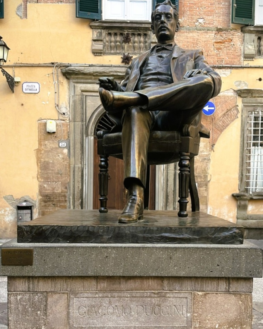 Statue of composer Giacomo Puccini in front of the Puccini Museum in Lucca, Italy, located in his birthplace at Piazza Cittadella.