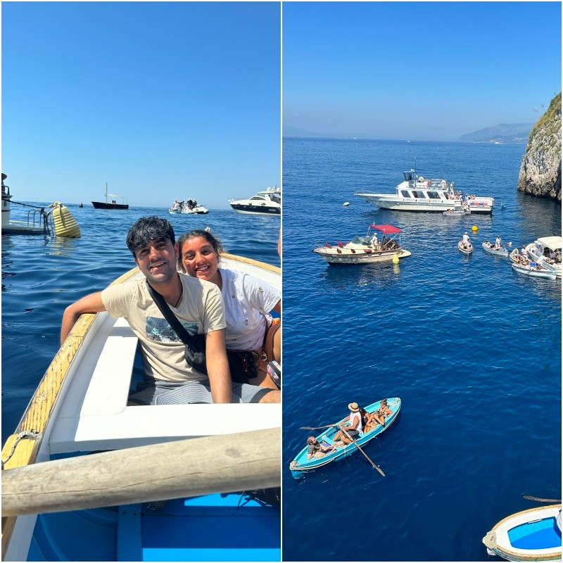 Teenagers in a rowboat near the Blue Grotto in Capri with tour boats waiting by the cliffside