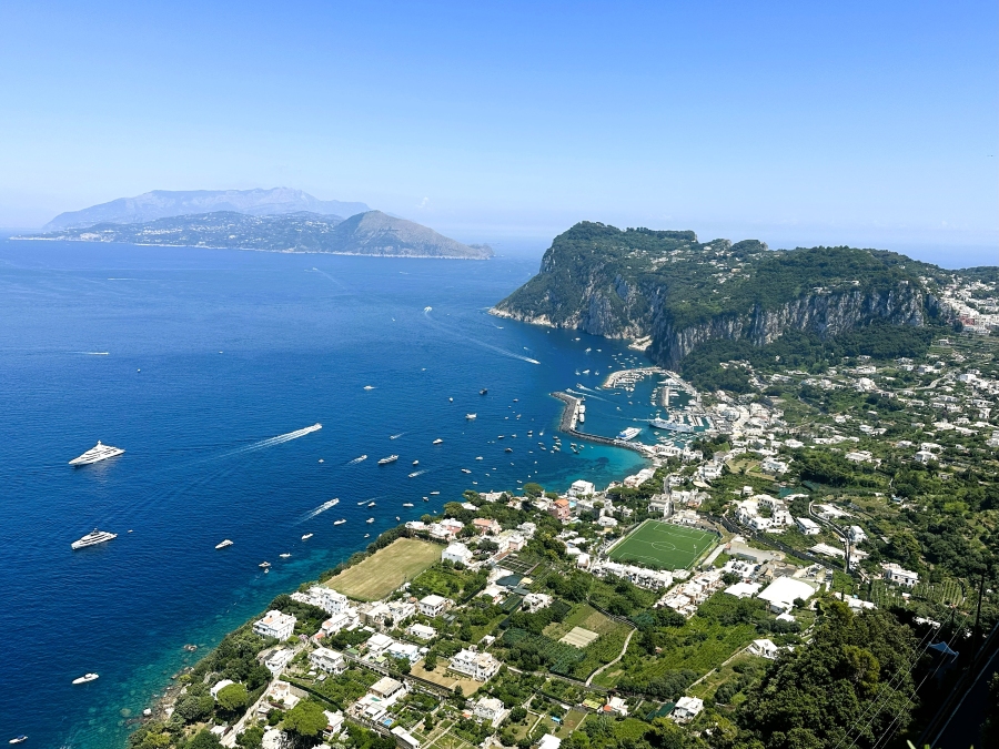 Wide panoramic view of Capri’s coastline and Marina Grande as seen from Anacapri near Villa San Michele.