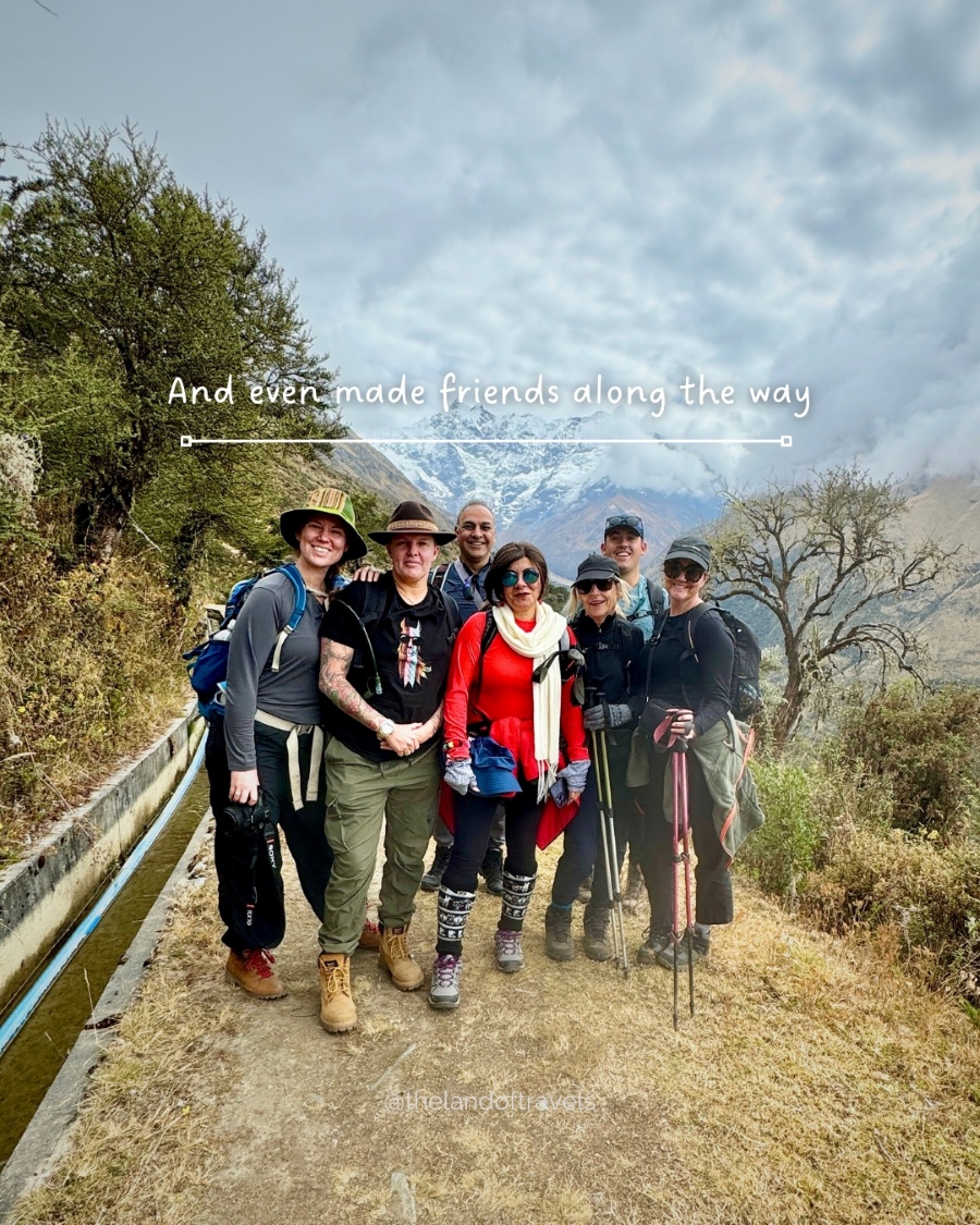 Group of hikers standing together on a trail during a shared travel experience