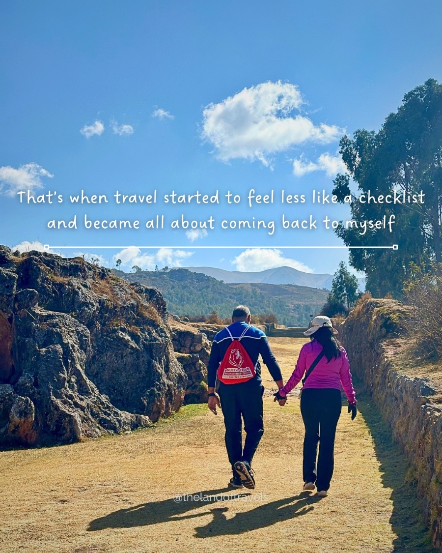 Two people walking hand in hand along a quiet path, reflecting on travel as a personal journey